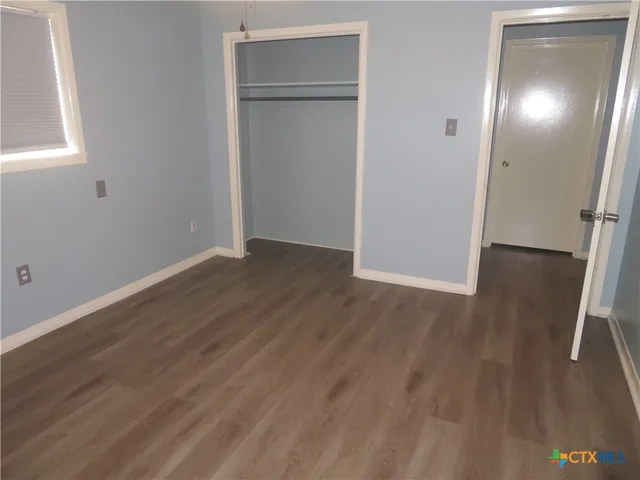 an empty room with wooden floor