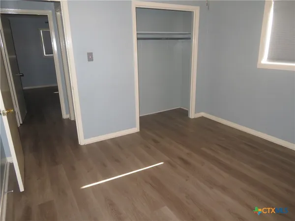 an empty room with wooden floor