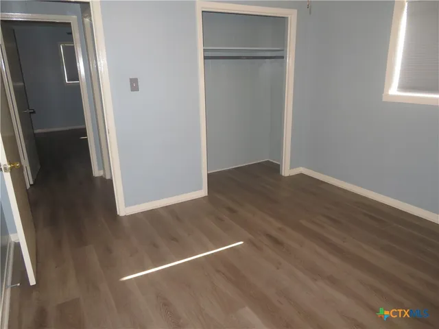 an empty room with wooden floor