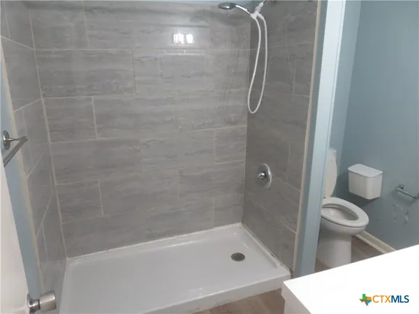 a bathroom with a tub and a shower