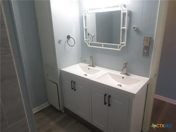 a bathroom with a sink and mirror