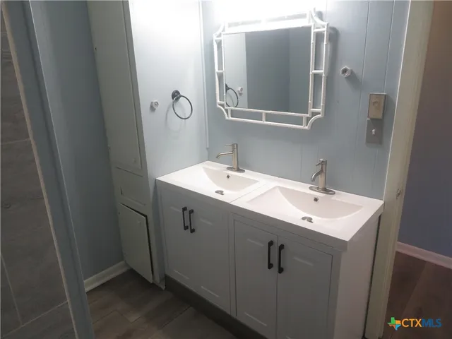 a bathroom with a sink and mirror