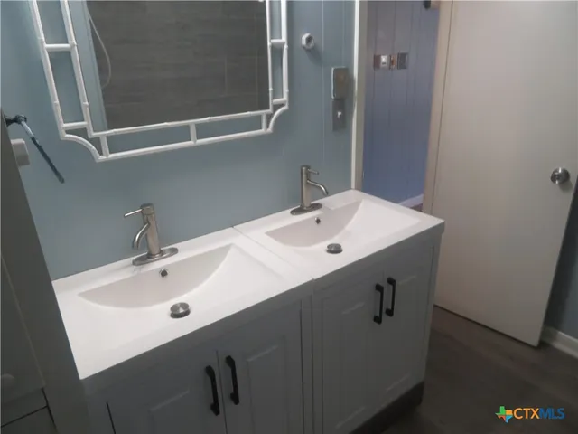 a bathroom with a sink and mirror