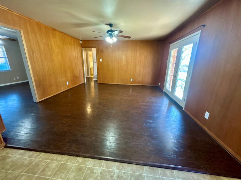406 Northwest 5th Street Hubbard, TX 76648 - Photo 22 of 40 a view of an empty room with wooden floor and a window