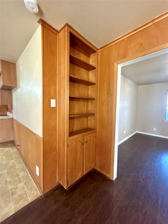 406 Northwest 5th Street Hubbard, TX 76648 - Photo 23 of 40 a view of an empty room with wooden floor and a bathroom