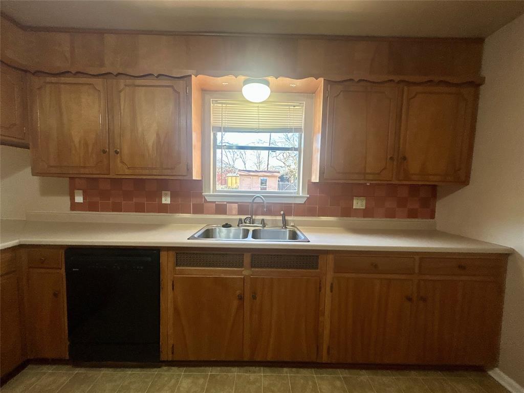406 Northwest 5th Street Hubbard, TX 76648 - Photo 26 of 40 a kitchen with a sink cabinets and window