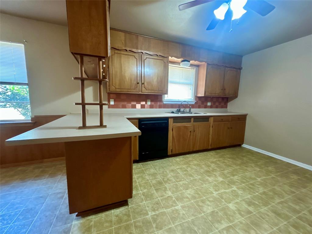 406 Northwest 5th Street Hubbard, TX 76648 - Photo 27 of 40 a kitchen with stainless steel appliances granite countertop a sink counter space and a window