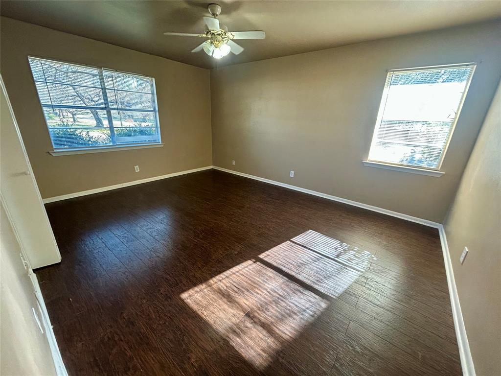 406 Northwest 5th Street Hubbard, TX 76648 - Photo 5 of 40 a view of wooden floor and windows in an empty room