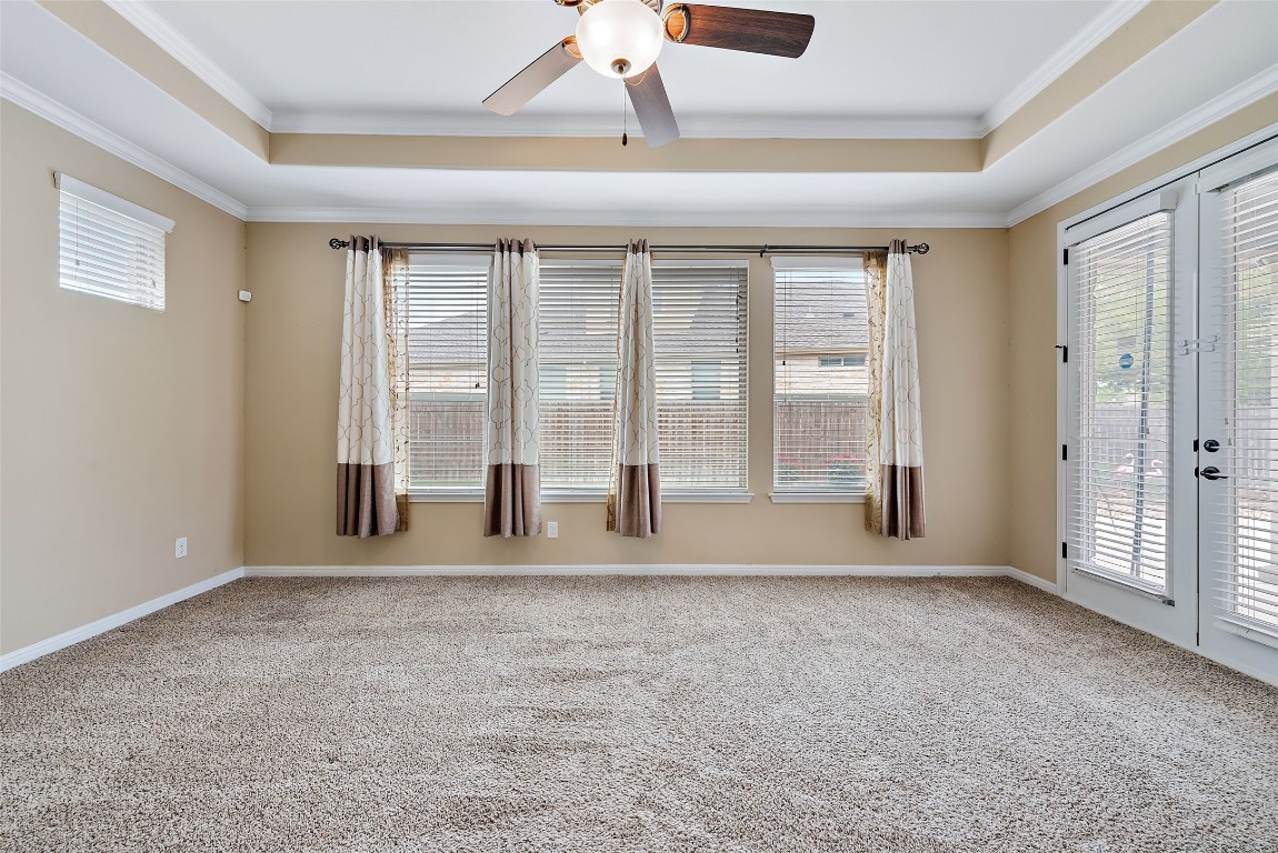 2000 Manada Trail Leander, TX 78641 - Photo 20 of 36 A spacious room offers high ceilings and ample light through multiple windows and glass doors.
