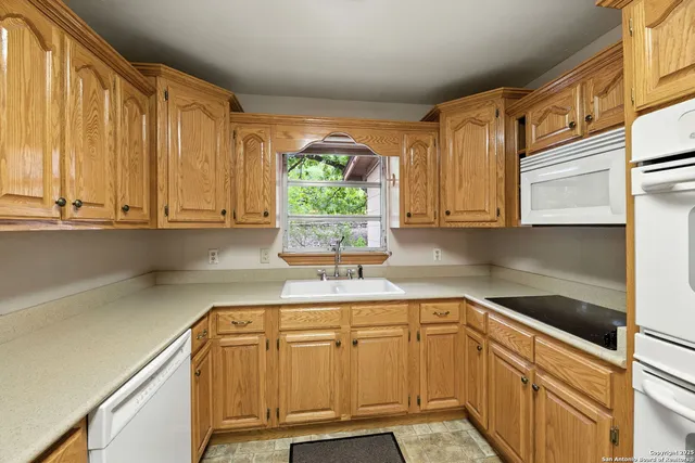 a kitchen with stainless steel appliances a white cabinets and a sink
