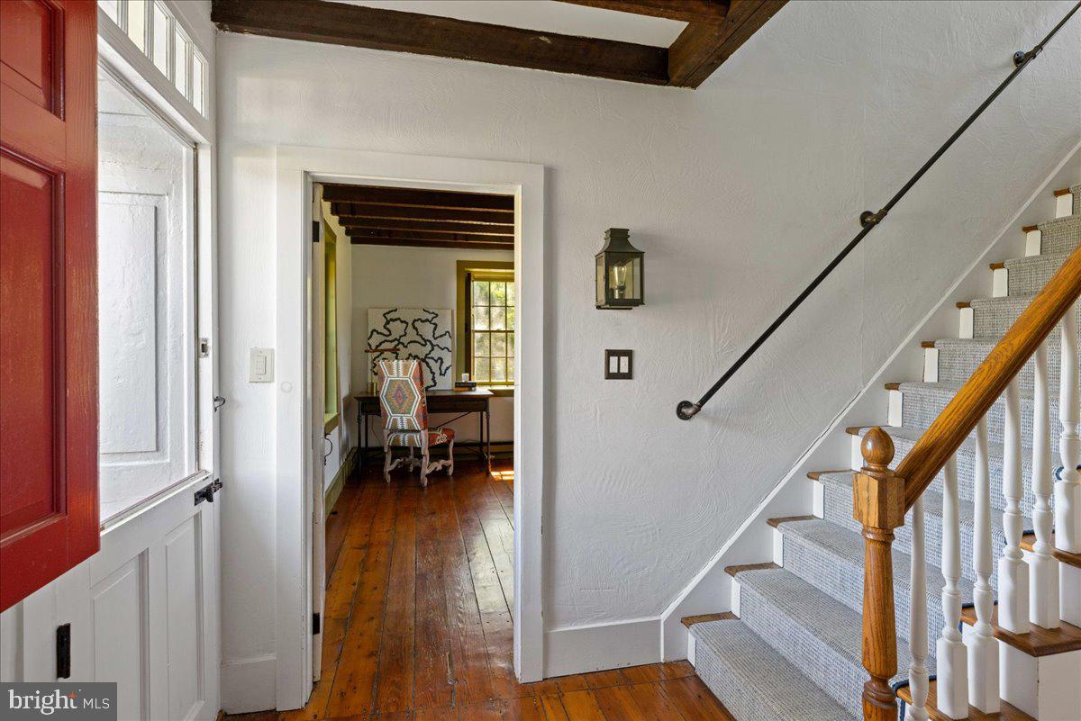 481 Quarry Road Ottsville, PA 18942 - Photo 22 of 64 a view of a hallway to a livingroom with wooden floor and furniture