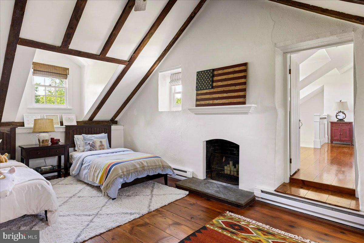 481 Quarry Road Ottsville, PA 18942 - Photo 39 of 64 a bedroom with two beds and a fireplace