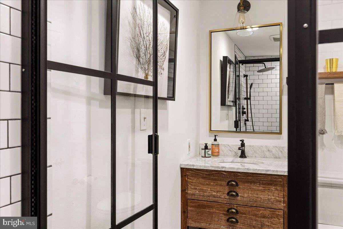 481 Quarry Road Ottsville, PA 18942 - Photo 40 of 64 a bathroom with a shower sink and mirror