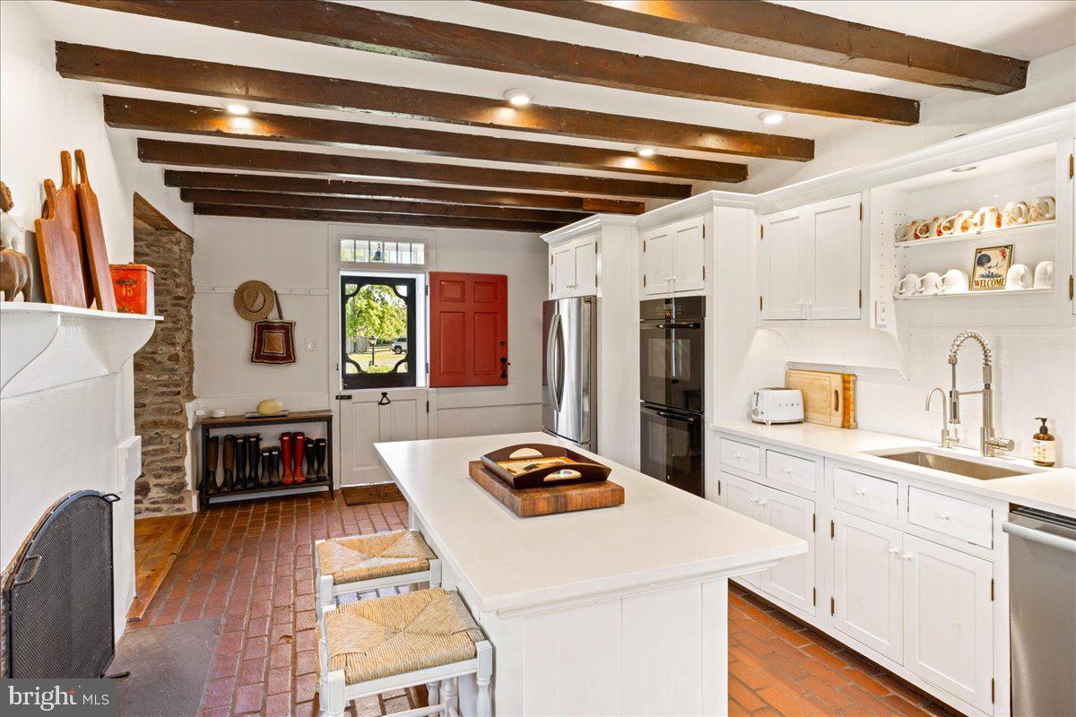 481 Quarry Road Ottsville, PA 18942 - Photo 10 of 64 a kitchen with stainless steel appliances granite countertop a stove and a refrigerator