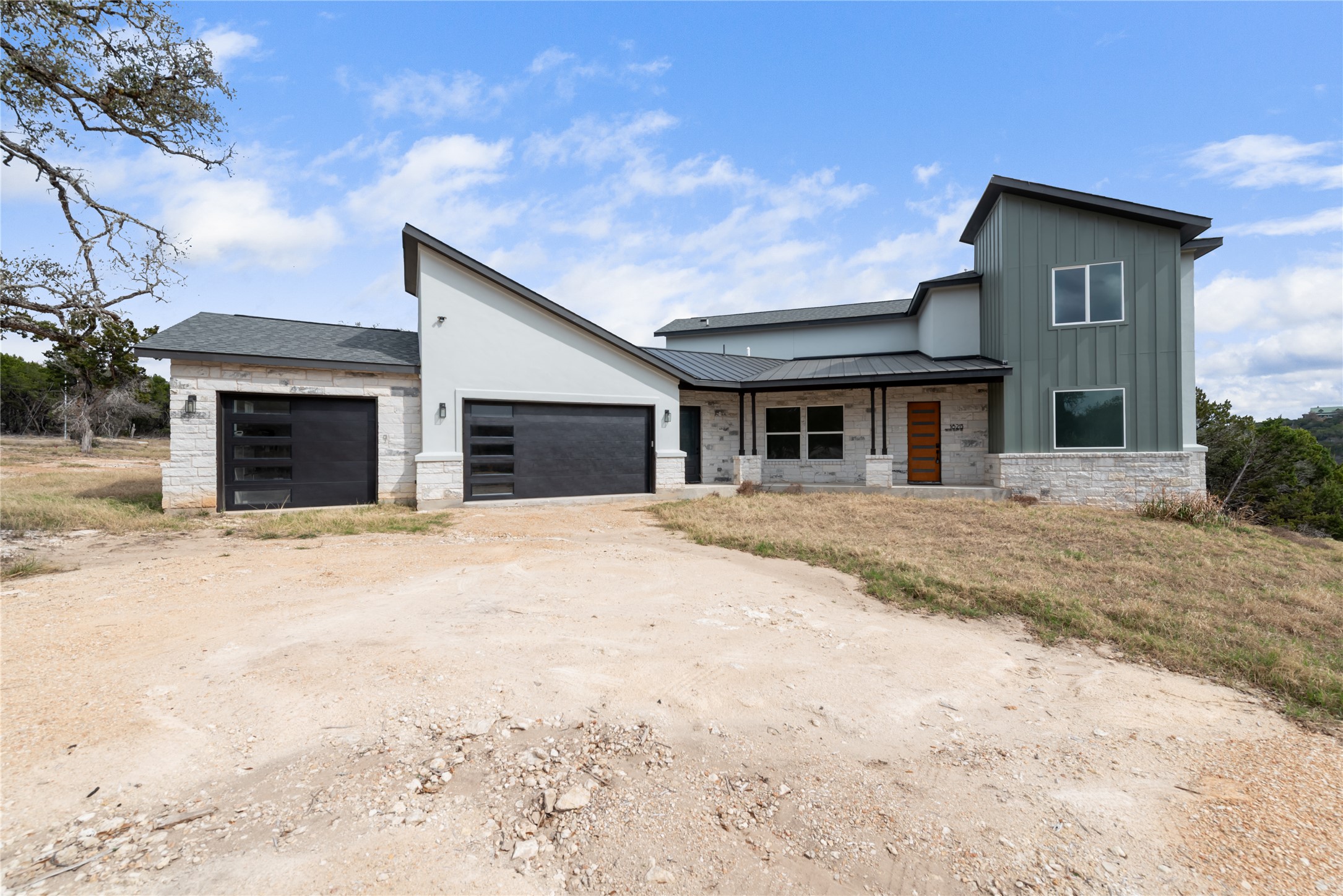 18213 Gregg Bluff Road Jonestown, TX 78645 - Photo 1 of 1 a front view of a house with a yard and garage