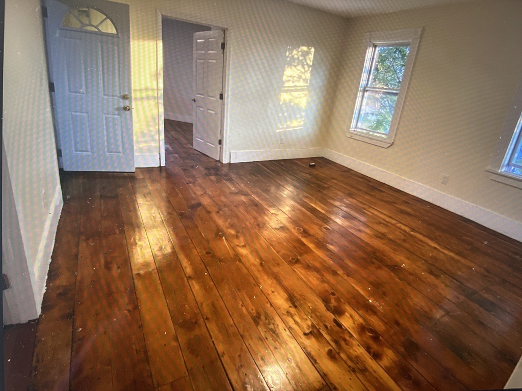 15 Norfolk Street Worcester, MA 01604 - Photo 12 of 18 an empty room with wooden floor and windows