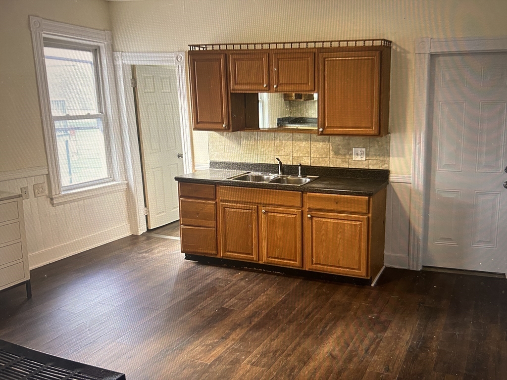 15 Norfolk Street Worcester, MA 01604 - Photo 14 of 18 a kitchen with stainless steel appliances granite countertop a stove a sink and a microwave