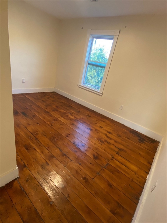 15 Norfolk Street Worcester, MA 01604 - Photo 16 of 18 an empty room with wooden floor and windows