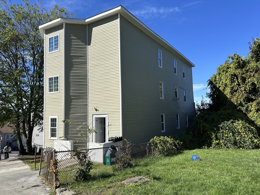 15 Norfolk Street Worcester, MA 01604 - Photo 2 of 18 a backyard of a house with potted plants and large tree
