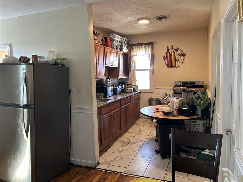 15 Norfolk Street Worcester, MA 01604 - Photo 3 of 18 a kitchen with a refrigerator and a stove