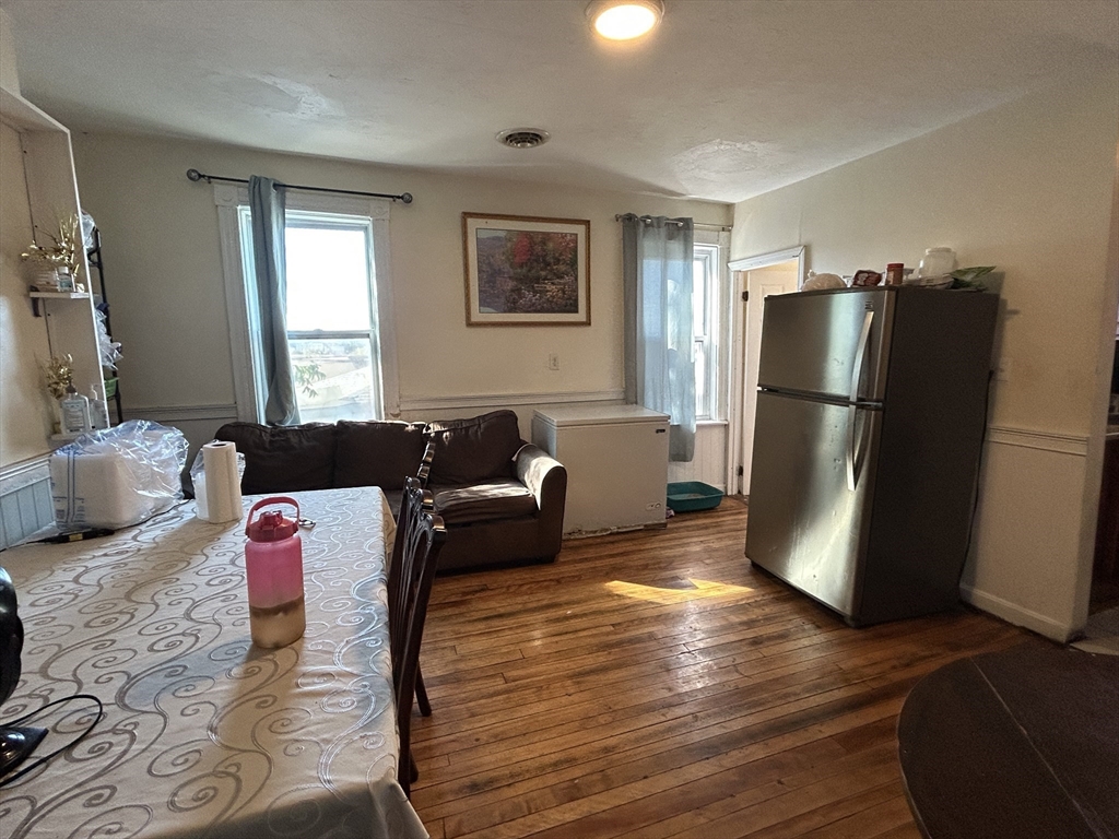 15 Norfolk Street Worcester, MA 01604 - Photo 5 of 18 a living room with furniture and a refrigerator