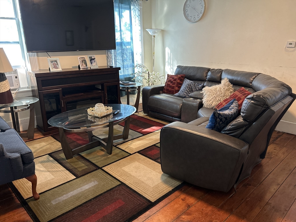 15 Norfolk Street Worcester, MA 01604 - Photo 6 of 18 a living room with furniture and a flat screen tv