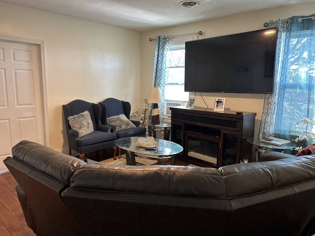 15 Norfolk Street Worcester, MA 01604 - Photo 7 of 18 a living room with furniture and a flat screen tv