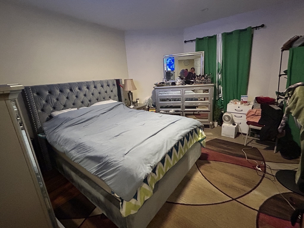 15 Norfolk Street Worcester, MA 01604 - Photo 8 of 18 a bed sitting in a bedroom next to a window
