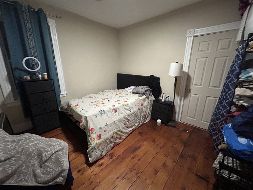 15 Norfolk Street Worcester, MA 01604 - Photo 9 of 18 a bedroom with a bed and a mirror