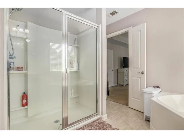 a bathroom with a shower sink and mirror