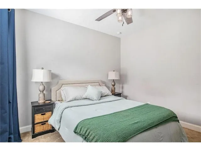 a bedroom with a bed and painting on the wall