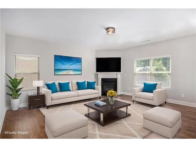 a living room with furniture a fireplace and a flat screen tv