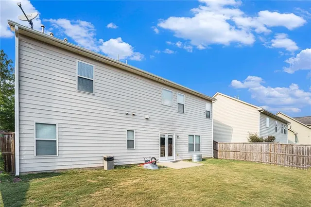 a view of a house with a swimming pool and sitting area