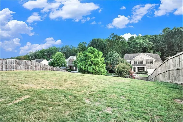 a view of a house with a yard and sitting area