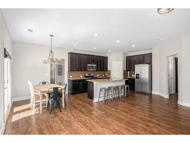 a kitchen with a table and chairs in it