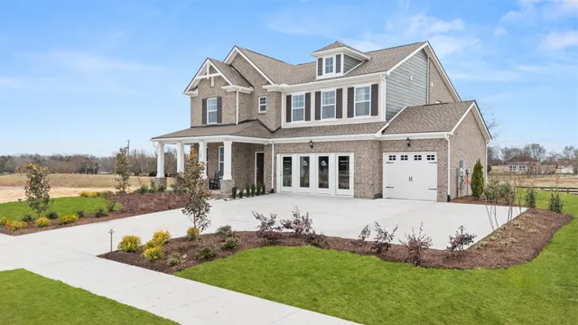a front view of a house with a yard table and chairs
