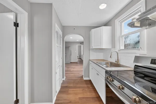 a kitchen with stainless steel appliances granite countertop a sink and cabinets