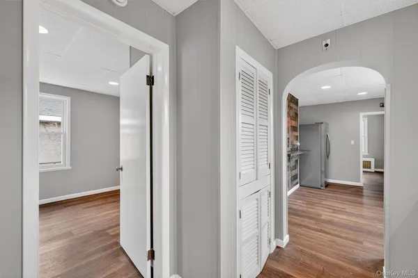 a view of a hallway with wooden floor