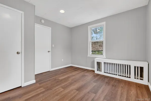 a view of a room with wooden floor and windows