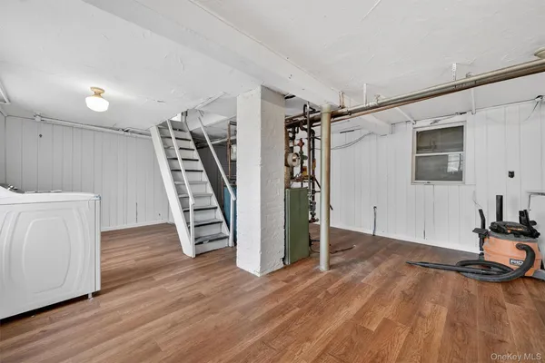 a view of a room with wooden floor and stairs