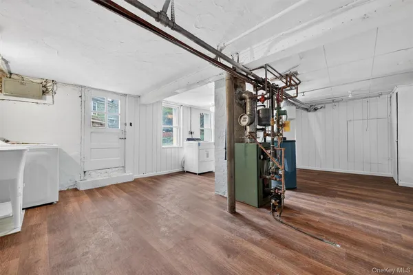 a view of a room with wooden floor and windows