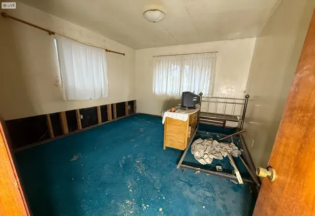 a bed room with furniture and a window