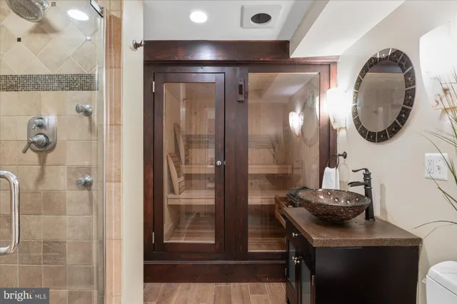 a front view of a house with a yard and fountain in middle