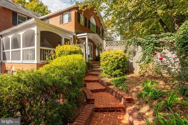 a view of a patio with couches table and chairs and potted plants