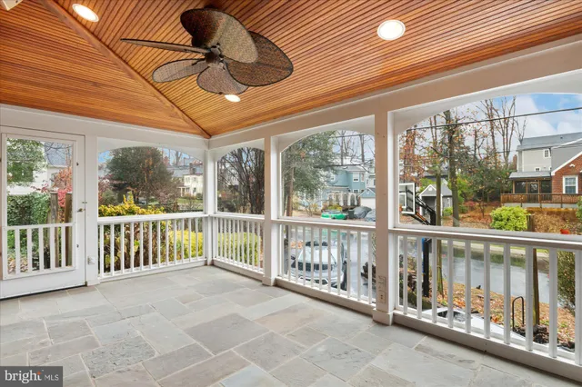 a view of a room with wooden floor and iron stairs