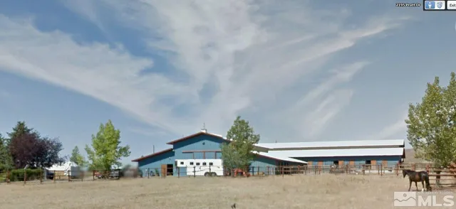 a couple of table and chairs in front of a house