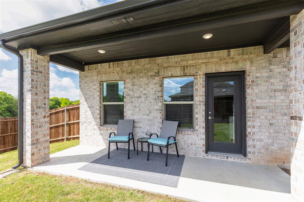 1504 Cobblestone Road Melissa, TX 75454 - Photo 31 of 39 Covered patio designed for shaded outdoor relaxation.