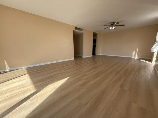 a view of an empty room and wooden floor