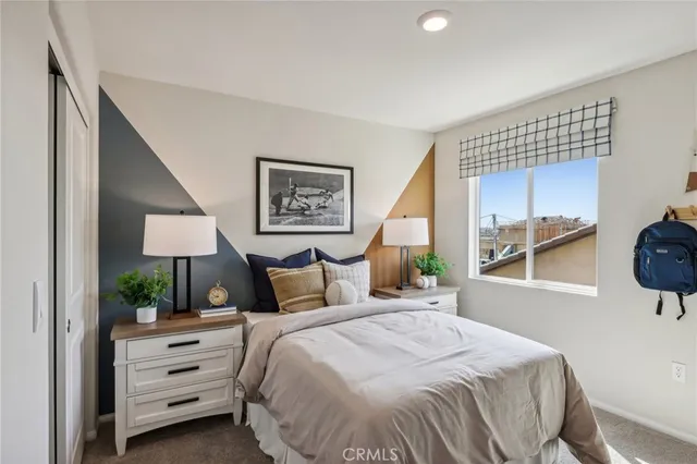 a bedroom with a bed and a window