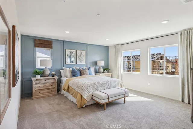 a spacious bedroom with a large bed and windows